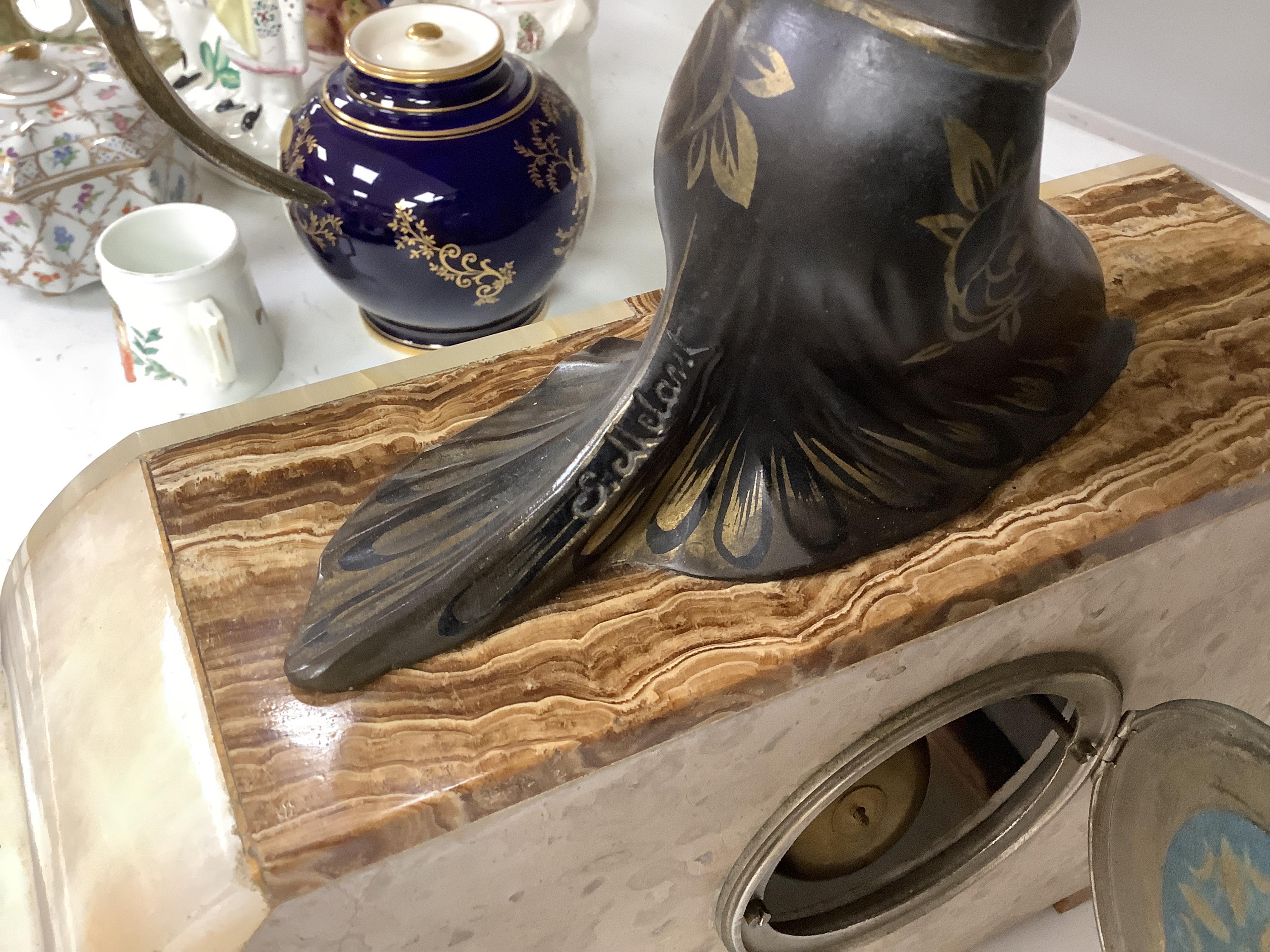 A French Art Deco onyx and spelter mantel clock, signed S. Moralni, with key and pendulum, 39cm